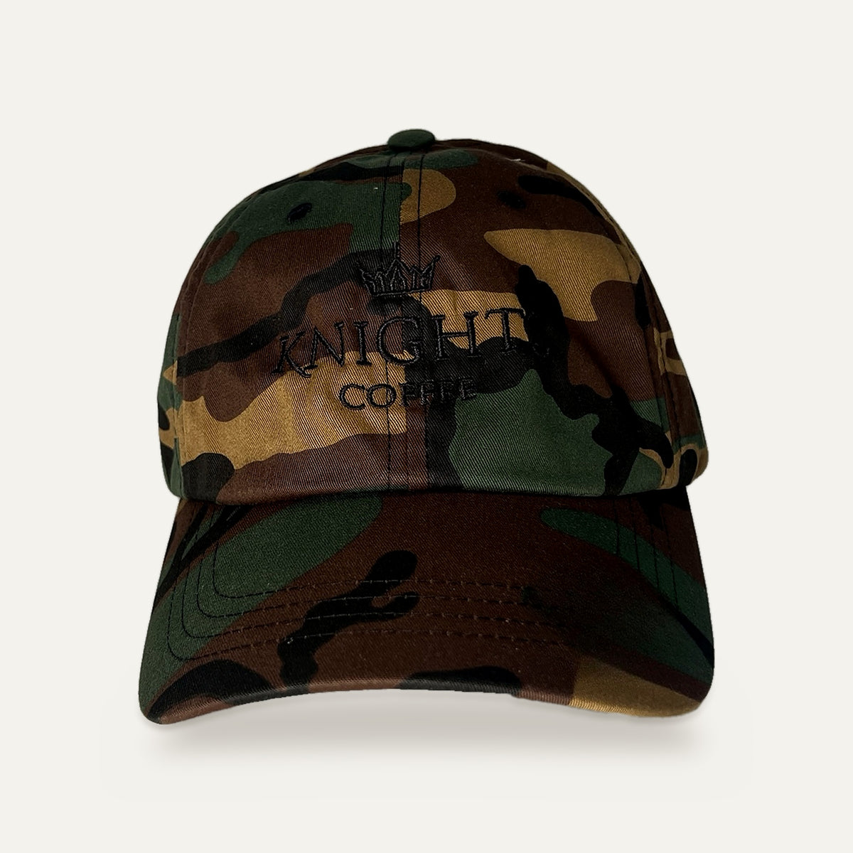 Knights Coffee woodland camo dad hat with black crown embroidery, front view