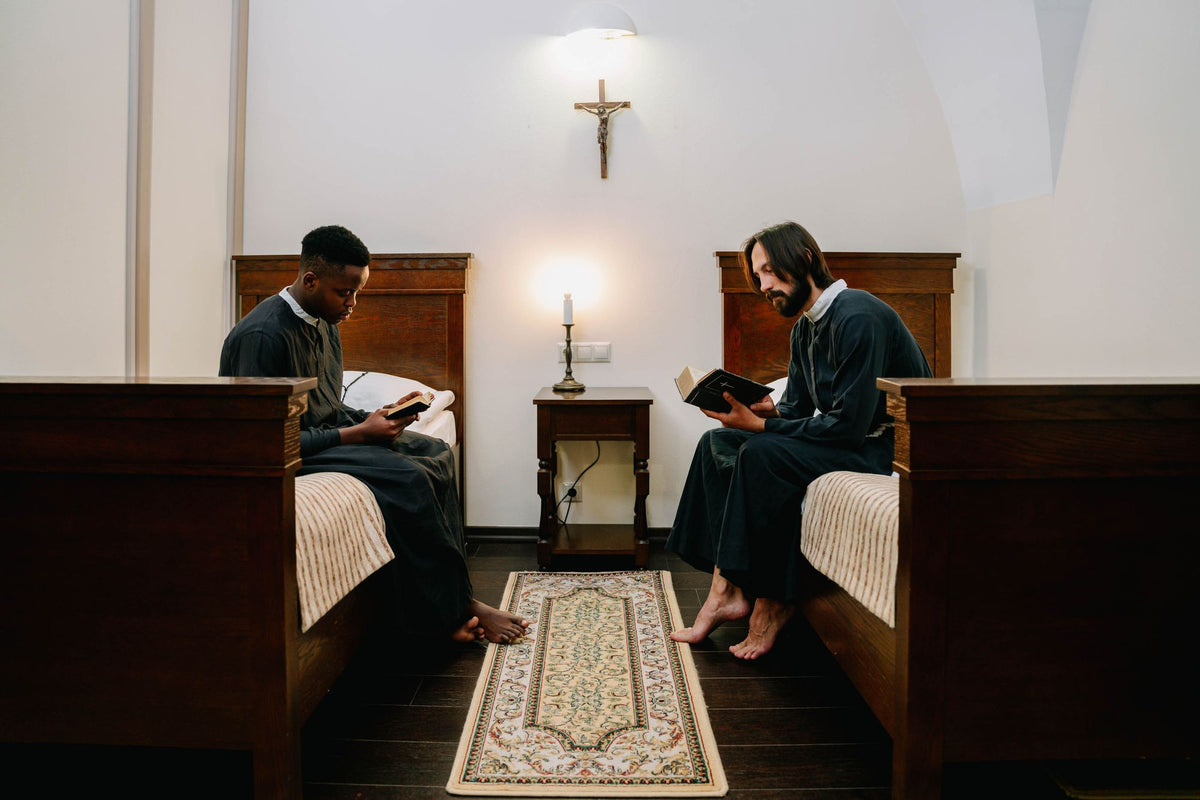 Two seminarians reading in their room at the seminary